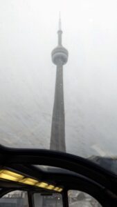 View of The CN tower from a park car on the Via Canadian